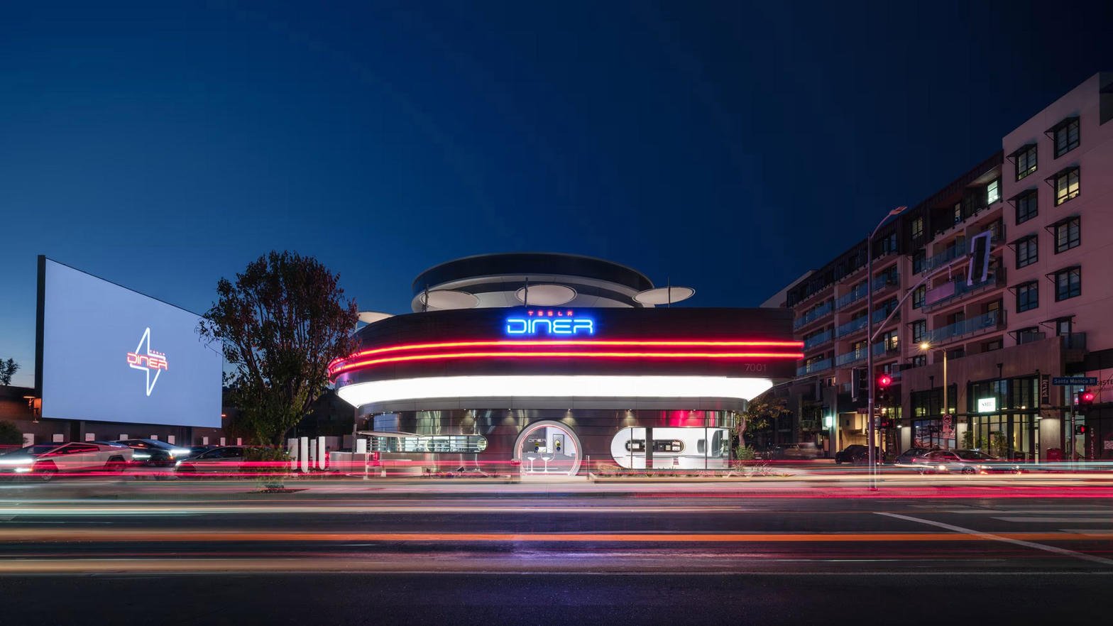 Tesla Diner exterior at night with neon and light trails